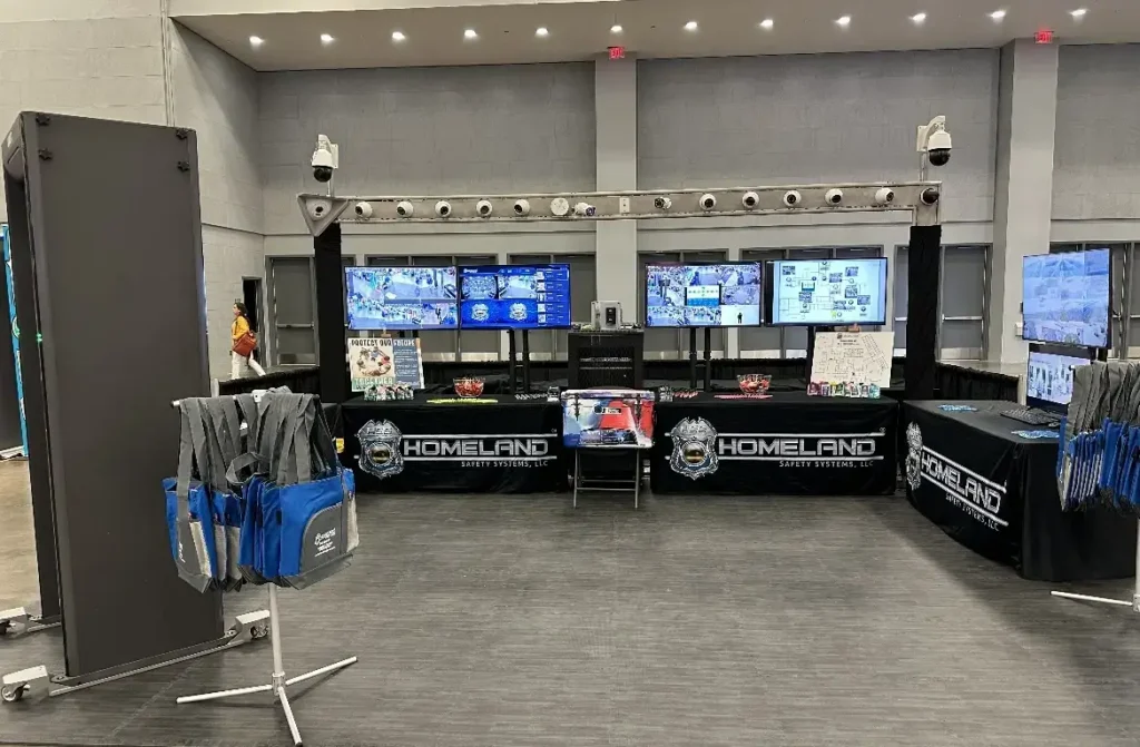 HSS trade-show booth with camera rig, metal detector and branded tables (company media library, 'Homeland Safety Systems Conference Booth', Feb 2024)